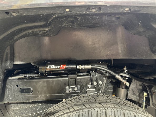 Ensure hose is closer possible to the frame and is not overbend or twisted. Note that the shock can be rotated to point hose fiting closer to the frame.