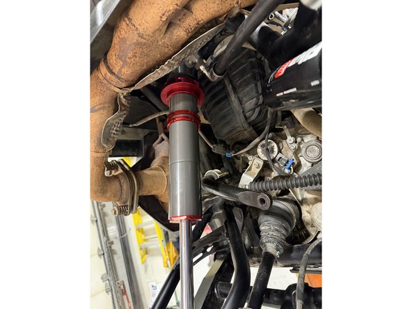 On models with rebound, the lower shock eyelets must be installed with the rebound adjuster oriented toward the rear of the vehicle. If needed, rotate the lower eyelet to ensure proper orientation.