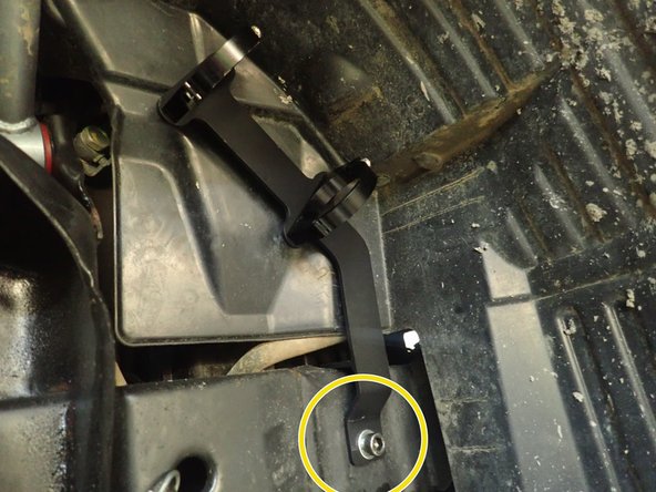 Use the bolt and the small washer provided, and pass it into the reservoir bracket as shown.