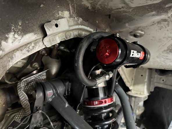 When the reservoir is placed properly,  torque bracket's bolts at 10 Ft-Lb.