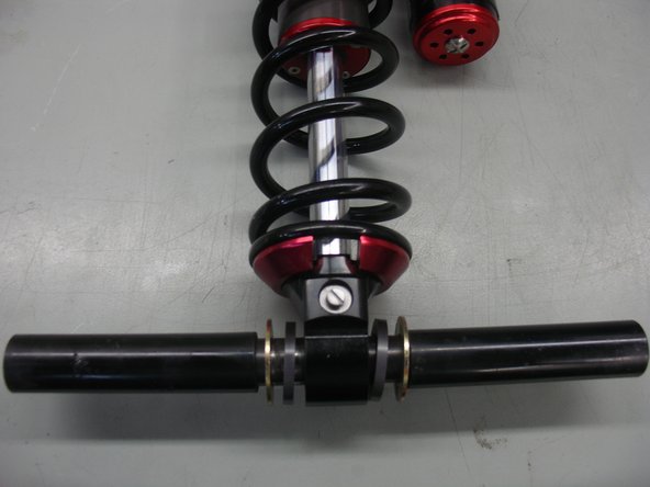 Install the sleeve through the bottom eye with the plastic spacer on both side of the eyelet.