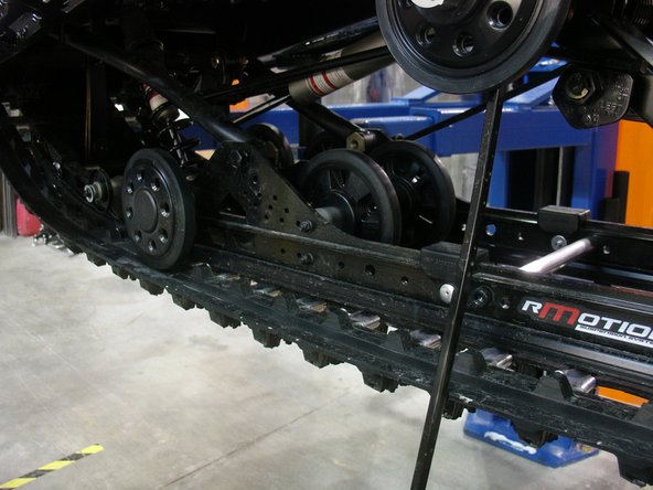 Lift the rear of the snowmobile in such a way that the track is not touching the ground.