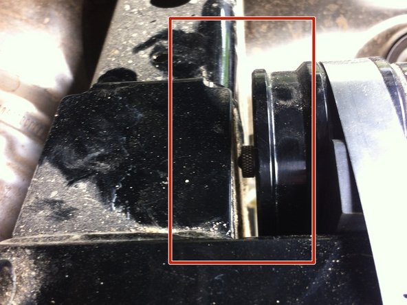 Route the hose properly and install the shock reservoir beside the frame as shown. Be sure the metal hose clamps screw are installed inward the vehicle as shown by the yellow arrows.