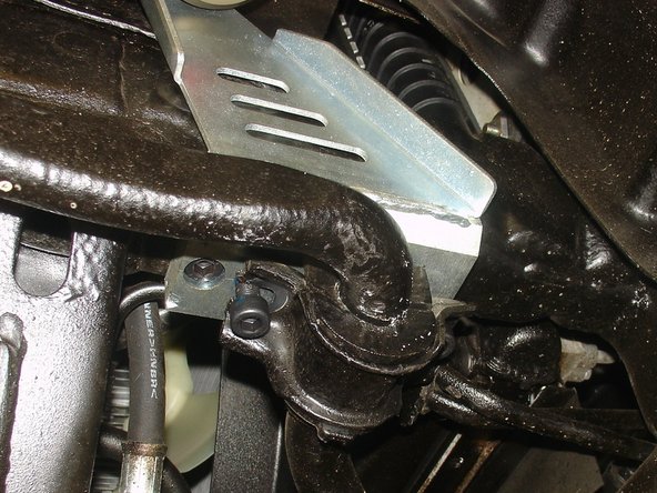 Install upper arm, sway bar link, brake line and install sway bar with the shorter supplied bolts into the Elka bracket as shown.