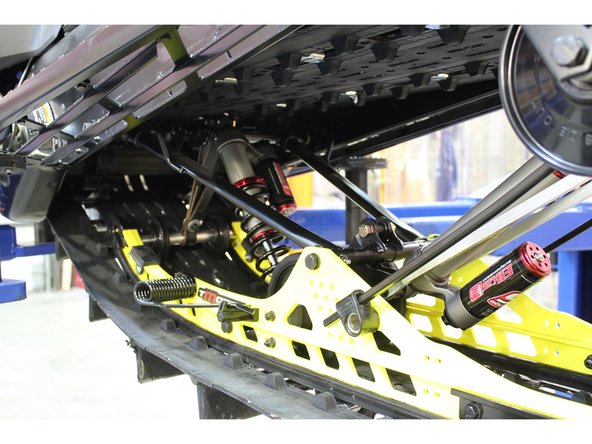 Install the Elka center shock with piggyback reservoir at the top and pointing towards the right side of the snowmobile as show on the photo.
