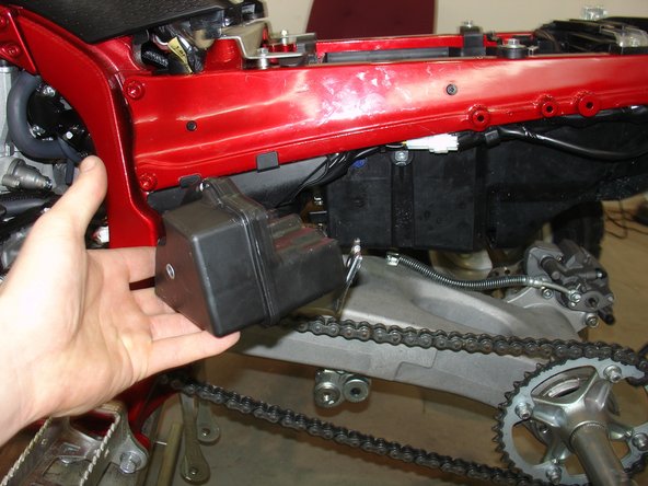 Remove the overflow oil tank.