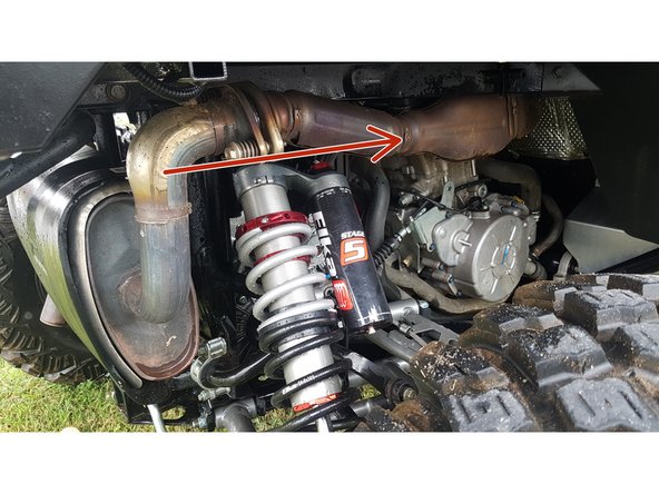 Install the left and right new Elka rear shock with the piggyback reservoir at the top and oriented towards the front of the vehicle as indicated by the red Arrow on the photo.