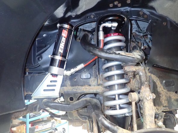 Install sway bar link and brake line bracket in place.