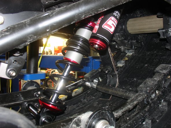 Install the Elka center shock with piggyback reservoir at the top and pointing towards the right side of the snowmobile as show on the photo.