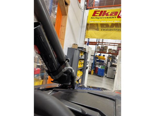 Install front remote reservoir shocks with the hoses facing the  rear of vehicle. (Left side shown).