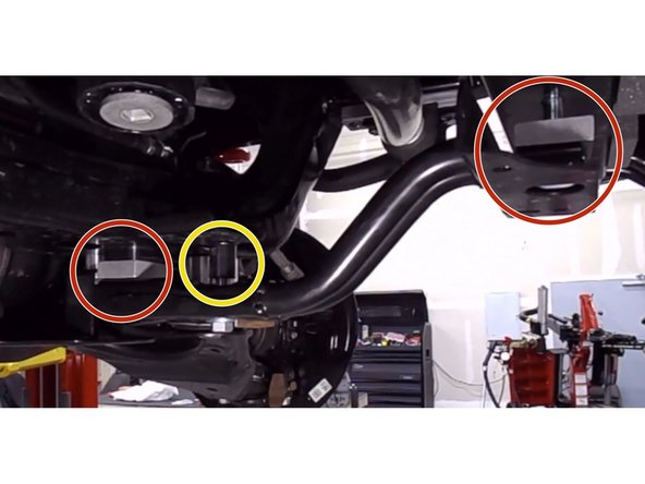 To avoid interference with the brackets that secure the radiator and the sway bar, install the spacers supplied between the brackets and the frame as shown. Use the big spacers in the places shown with red circles and small spacers in the place indicated by a yellow circle. Secure with the longer bolts provided.