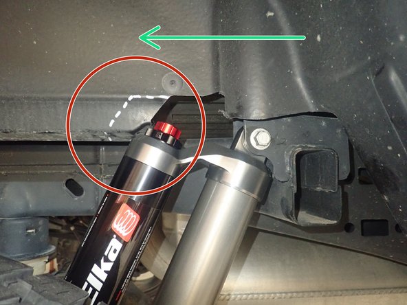 Both rear Elka shocks are the same, they must be installed with the piggyback reservoir facing up. The DRIVER'S SIDE reservoir must facing the REAR of vehicle as shown by red arrow, and the PASSENGER'S SIDE reservoir must facing REAR of vehicle as shown by green arrow.