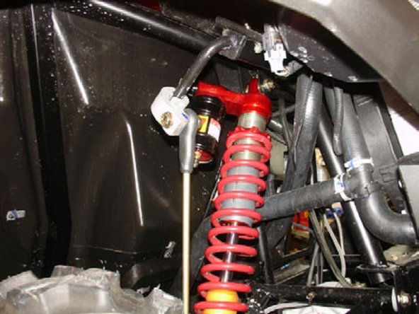 Passenger side: Install the Elka shock absorbers bolting the top mount first with the piggyback reservoirs towards the outside of the vehicule.