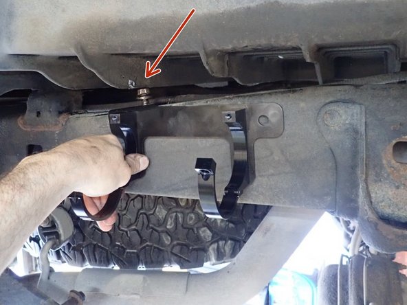 Install the right side reservoir holding bracket first with the bolt located on top of the frame .