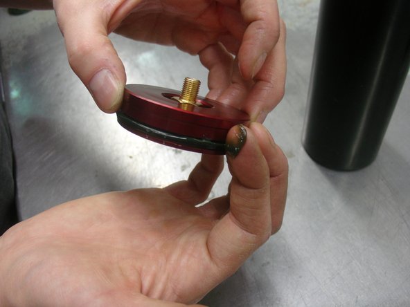 Apply some grease on the o-ring and push the cap Inside the reservoir.