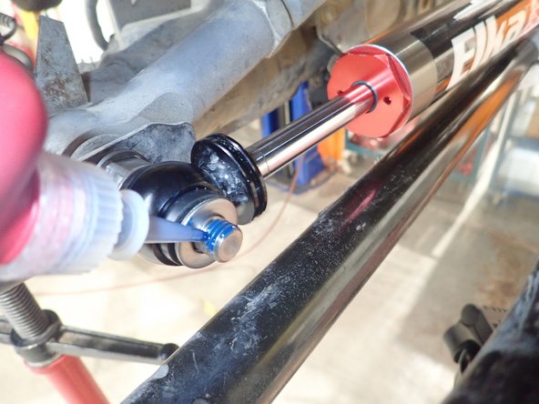 Apply thread locker on shaft threads and torque supplied nut at 70 Lb/Ft.