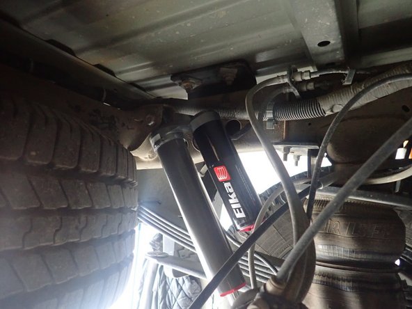 Install upper OEM bolt, Push on shock rod end to compress shock and install lower bolt. Tighten all bolts at 100 ft.lb.