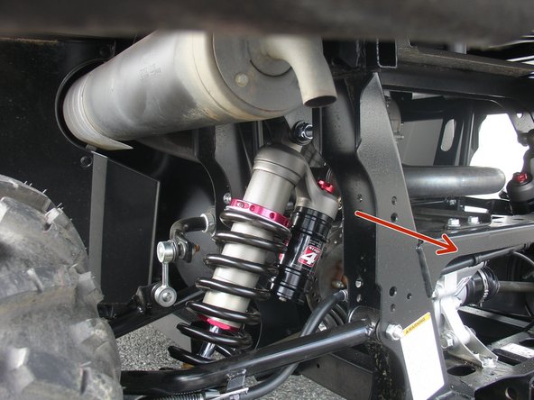 Install both new Elka rear shock with the piggyback reservoir at the top and oriented towards the inside of the vehicle as indicated by the red Arrow on the photo.