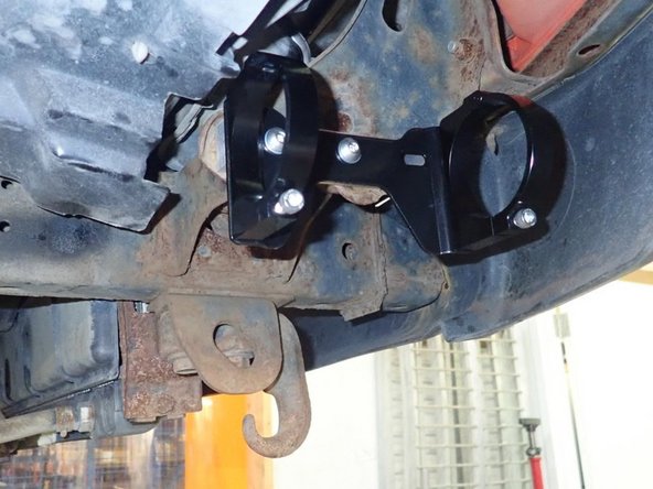 Using provided bolts and washers, fix reservoir holding bracket assembly into rectangular spacer as shown.