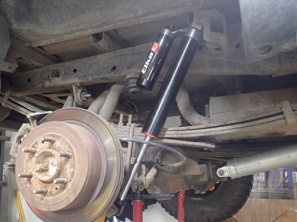 Lift the vehicle off the ground, then remove the oem shocks.