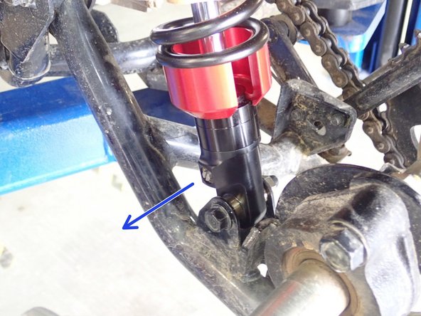 On Stage 2, Stage 4, and Stage 5 models the rebound adjuster located on lower eyelet of the shocks should be oriented towards the outside of the vehicle, as shown. (Left side shown ). If needed, you can turn the lower eyelet to orient properly.