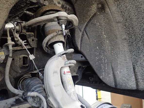 Separate upper control arms from steering knuckles.