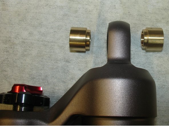 Install bushings with reduced diameter into o-rings, and hold them to put the shocks in place.