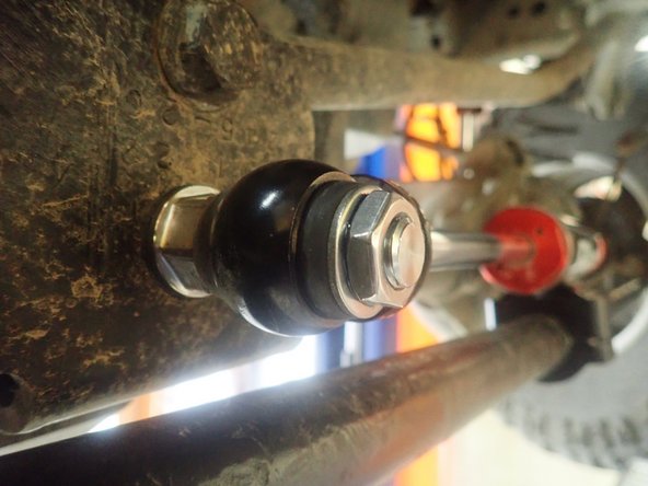 Apply thread locker on shaft threads and torque supplied thin nut at 70 Lb/Ft.