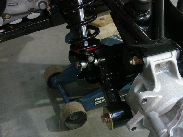 On Stage 2, Stage 4, and Stage 5 models the rebound adjuster located on lower eyelet of the shocks should be oriented towards the ouside of the vehicle, as shown. (Left side shown ). If needed, you can turn the lower eyelet to orient properly.