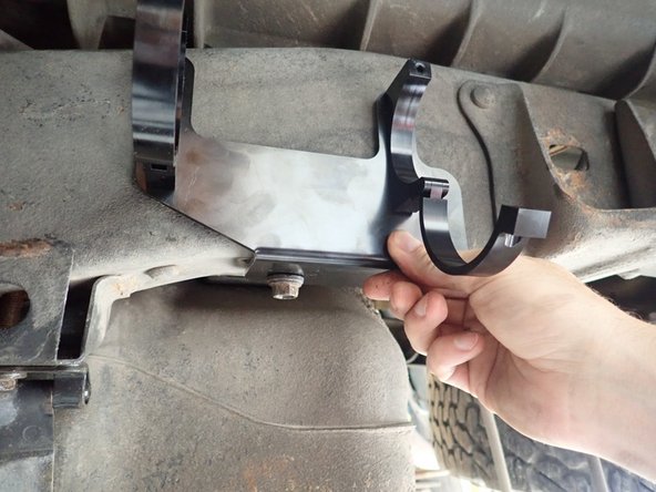 On the left side, use lower existing bolt to fix bracket, and use provided nylon-lock bolt in the existing hole to secure it.