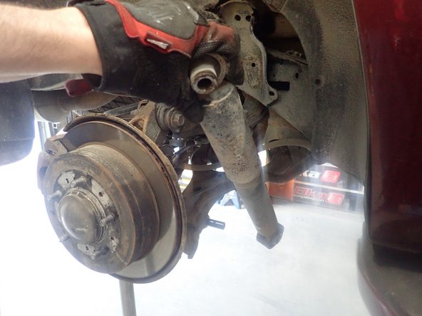 Remove upper and lower bolts and keep them to install Elka shocks.