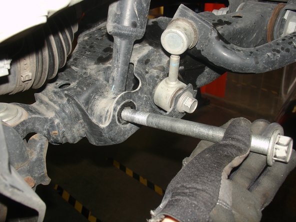 Remove lower shock bolt.