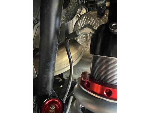 ON THE LEFT SIDE: When installed on vehicle with the shock head up: the the fitting on the head is facing the center of the vehicle as indicated by the blue arrow.