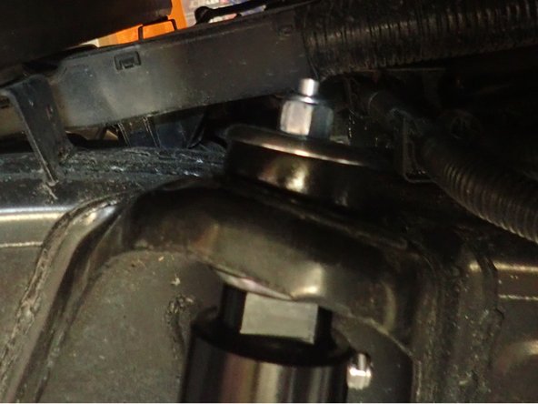 Insert the lower shock's eyelet on the stud first, then screw the lower bolt without tightening it.