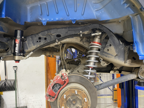 Both rear shocks are not the same. th hose must face the back of the vehicule like show in the picture. Right side show.