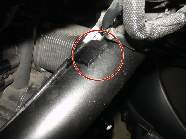 Install first part of bracket with threaded holes first, beside the frame. Be carefull to not install it over any cables. Install the bracket with the notches upside (see red circle).