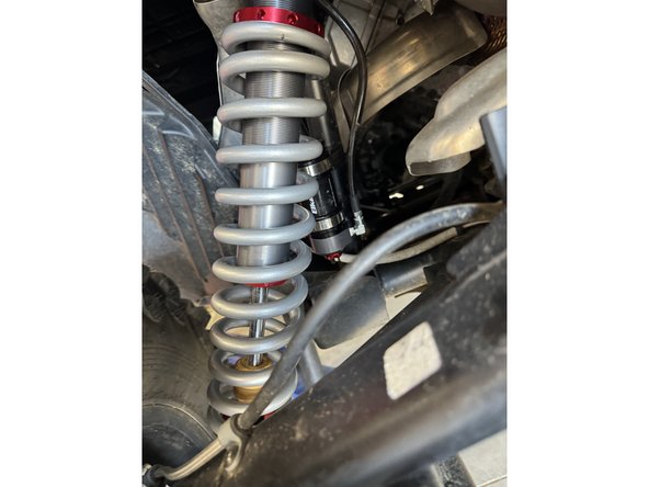 Route the hose properly and install the shock reservoir to the frame as shown. Use the reservoir holder that came with the shock.