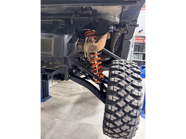 Remove the top bolt from the knuckle to remove the rear shocks.