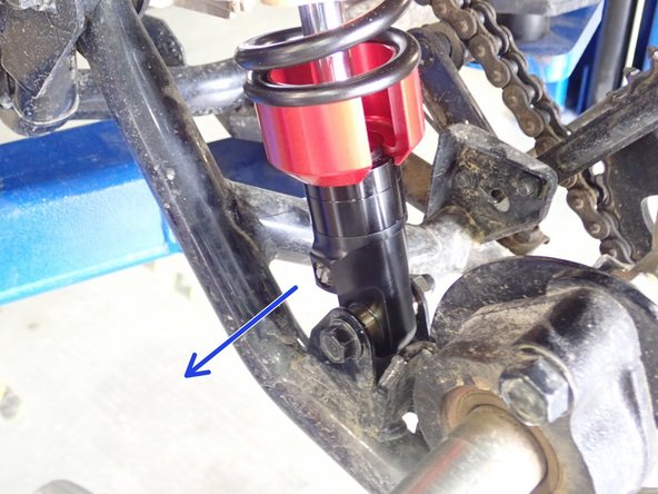 On Stage 2, Stage 4, and Stage 5 models the rebound adjuster located on lower eyelet of the shocks should be oriented towards the outside of the vehicle, as shown. (Left side shown ). If needed, you can turn the lower eyelet to orient properly.