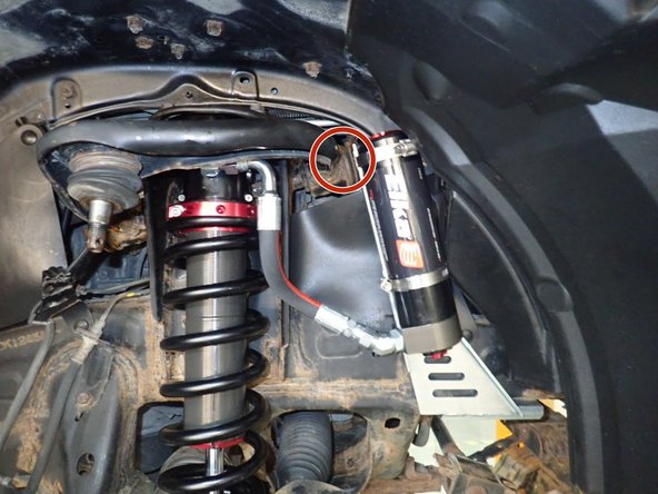 Sit the reservoir into bracket, locating it as high as possible while aligning the hose as close to the chassis possible. (right side shown)