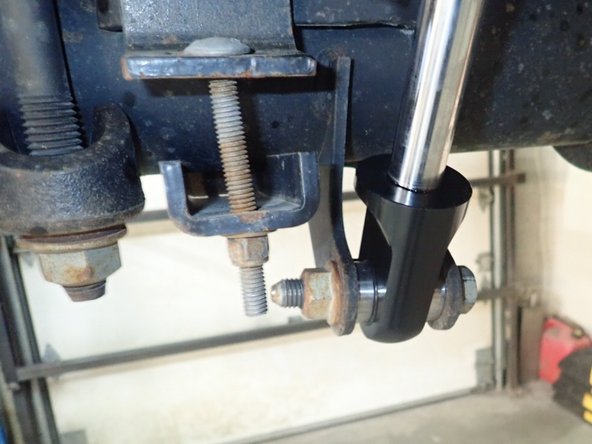 RIGHT SIDE: Install rear right shock with head to the top and reservoir facing front of vehicle as shown.