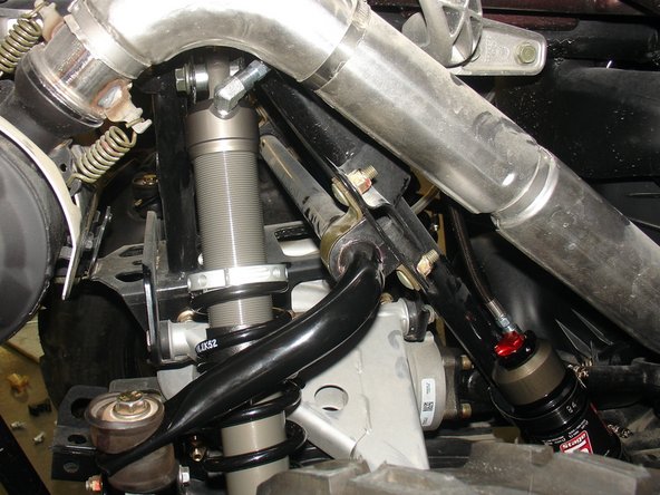 With the supplied rubber mount assembly, attach the reservoir on the frame as shown.  Note the rubber part is placed between the frame and the reservoir.