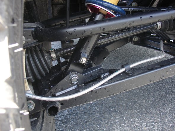 On Stage 2, Stage 4, and Stage 5 models the rebound adjuster located on lower eyelet of the shocks should be oriented towards the rear of the vehicle, as shown. (Left side shown ). If needed, you can turn the lower eyelet to orient properly.