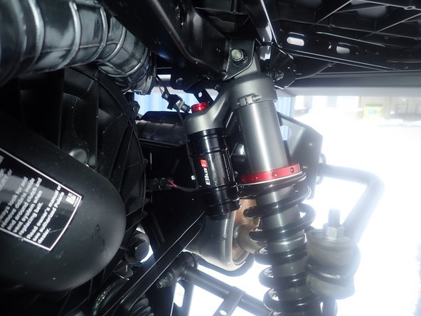 Install the rear new Elka shocks with the head at the top of vehicle. For Stage 3-4-5 shocks, reservoir must face the INSIDE of vehicle. (LEFT SIDE SHOWN)