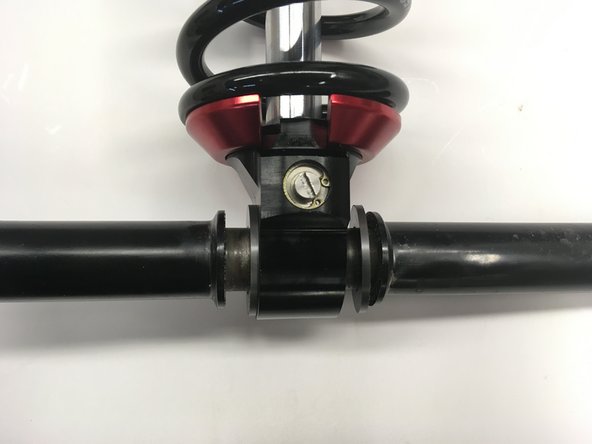 Install the sleeve through the bottom eye with the plastic spacer on both side of the eyelet.