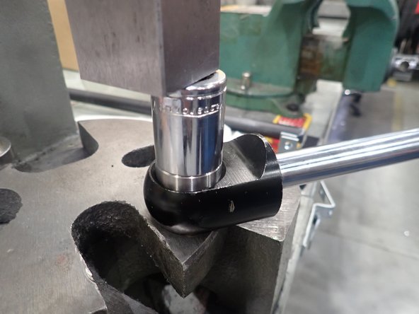 On the other side of the shock's end, press new bearing. Using the same small socket from the previous step, push bearing into its bore until it comes into contact with the  previously installed clip. DO NOT PUT TOO MUCH LOAD ON CLIP TO AVOID DEFORMING IT.