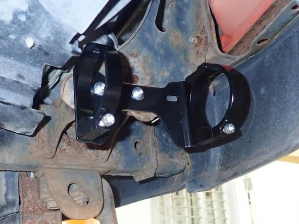 Using provided bolts and washers, fix reservoir holding bracket assembly into rectangular spacer as shown.