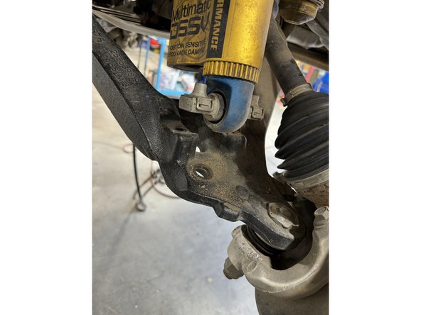 Remove the bolts from the lower shock mounts.