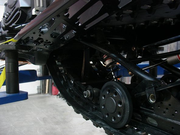 Remove the limiter strap and idler wheels.