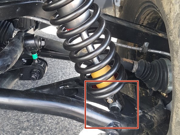 On Stage 2, Stage 4, and Stage 5 models the rebound adjuster located on lower eyelet of the shocks should be oriented towards the rear of the vehicle, as shown. (Shown by the red square ). If needed, you can turn the lower eyelet to orient properly.
